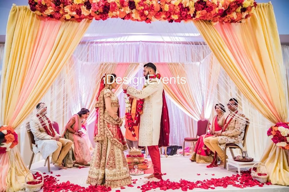 Bride and groom exchange garlands in a traditional Indian wedding ceremony.
