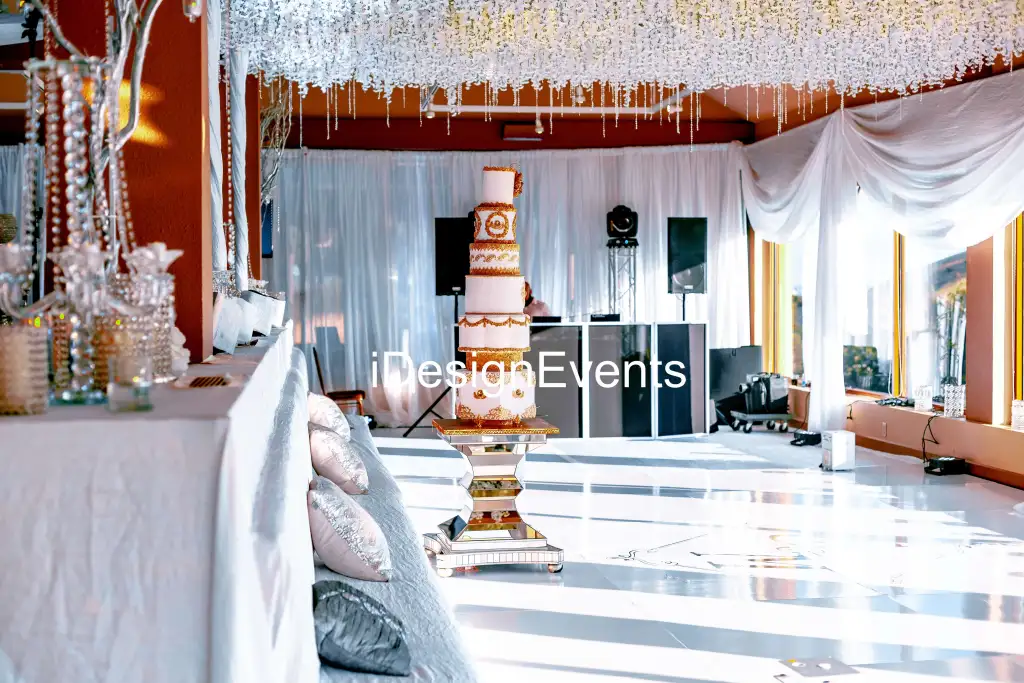 Elegant wedding setup with floral decorations and white drapes.