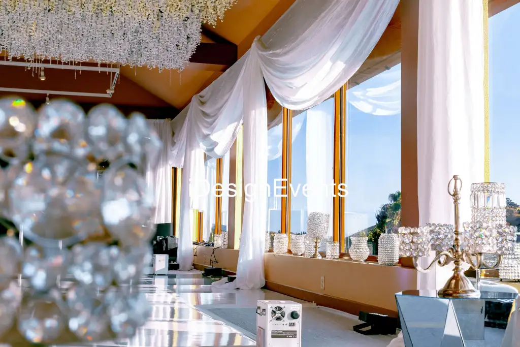 Elegant indoor seating area with large windows and soft drapes.