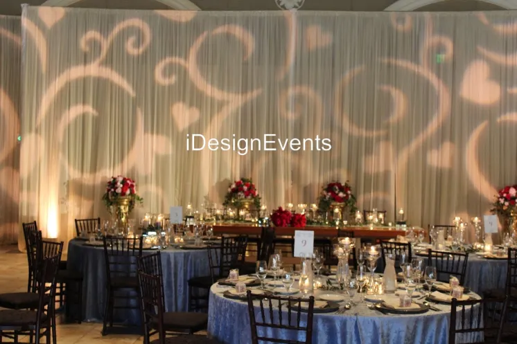 Elegant event setup with warm lighting and floral centerpieces at DesignEvents.