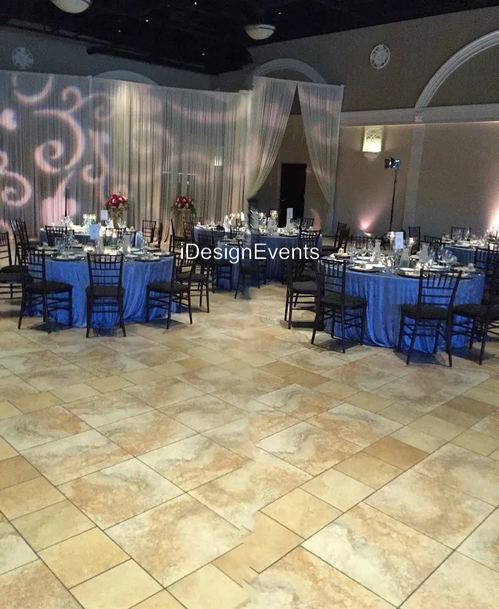 Elegant event setup with blue tablecloths and sophisticated lighting.