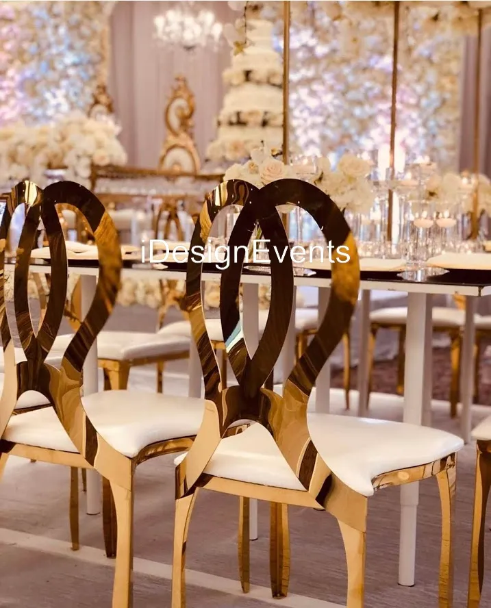 Elegant chairs with heart-shaped backs at a decorated event venue.