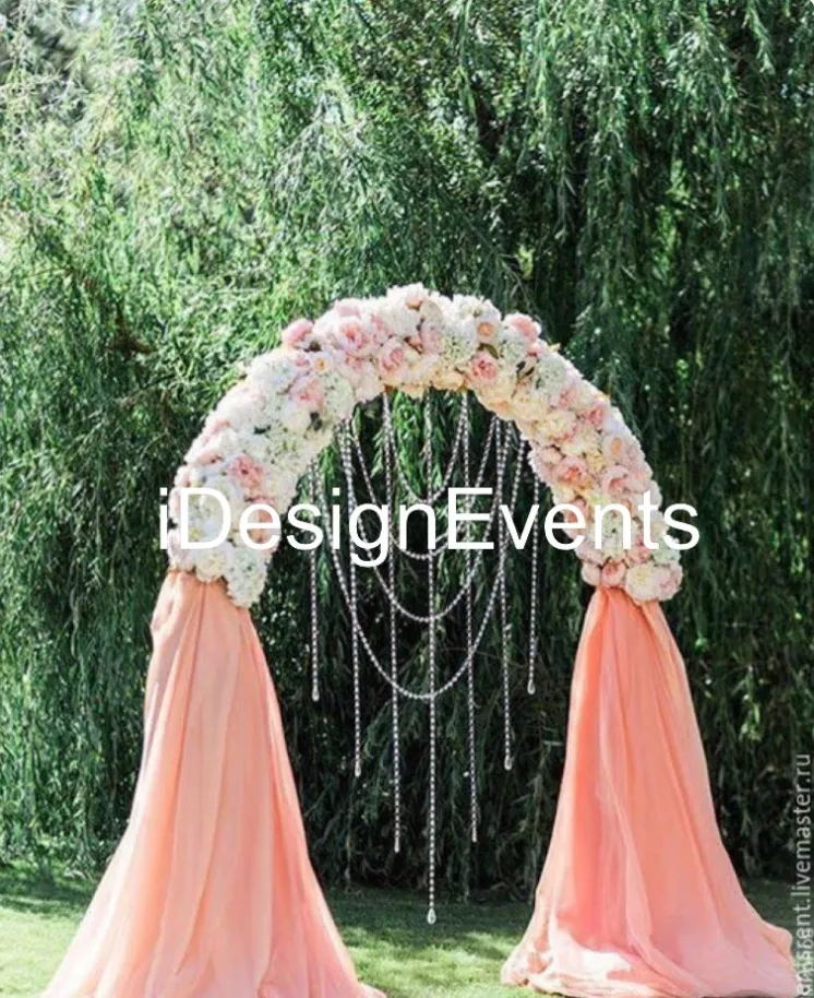 Elegant floral arch with peach drapes and cascading crystals.