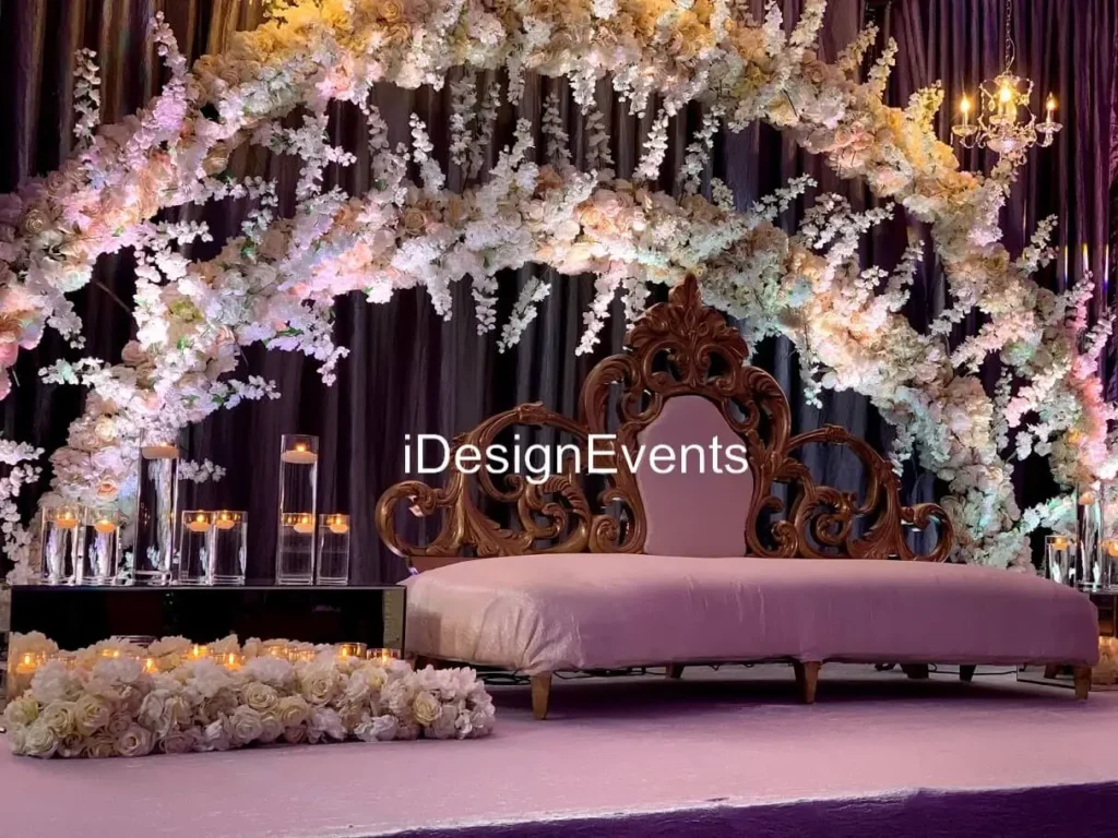 Elegant floral arch and plush seating at a sophisticated event setup.
