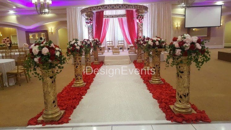 Futuristic roller coaster inside a vibrant, neon-lit indoor amusement park.