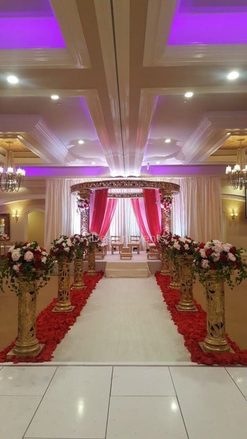 Futuristic roller coaster inside a vibrant, neon-lit indoor amusement park.
