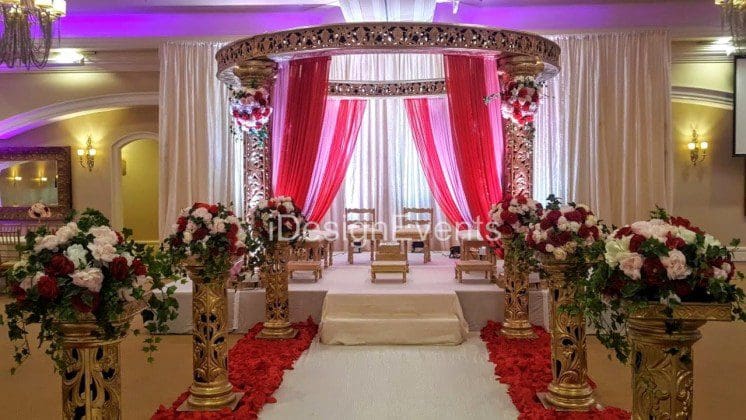 Futuristic roller coaster inside a vibrant, neon-lit indoor amusement park.