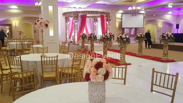 Futuristic roller coaster inside a vibrant, neon-lit indoor amusement park.