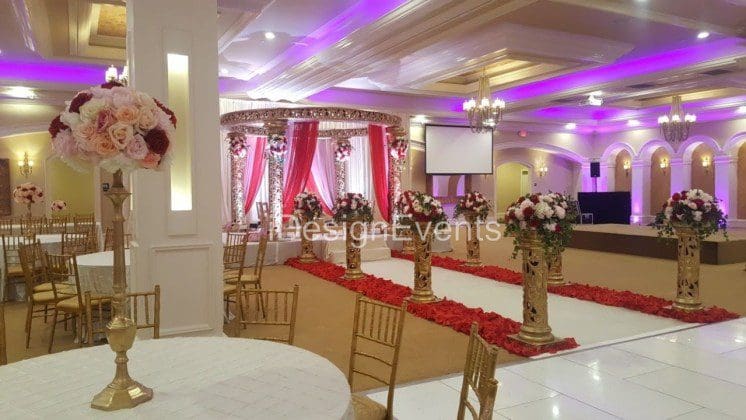 Futuristic roller coaster inside a vibrant, neon-lit indoor amusement park.