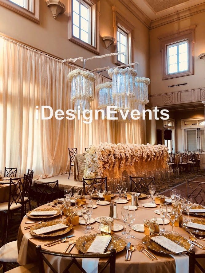 Elegant banquet hall with sophisticated table settings and floral centerpieces for a special event.