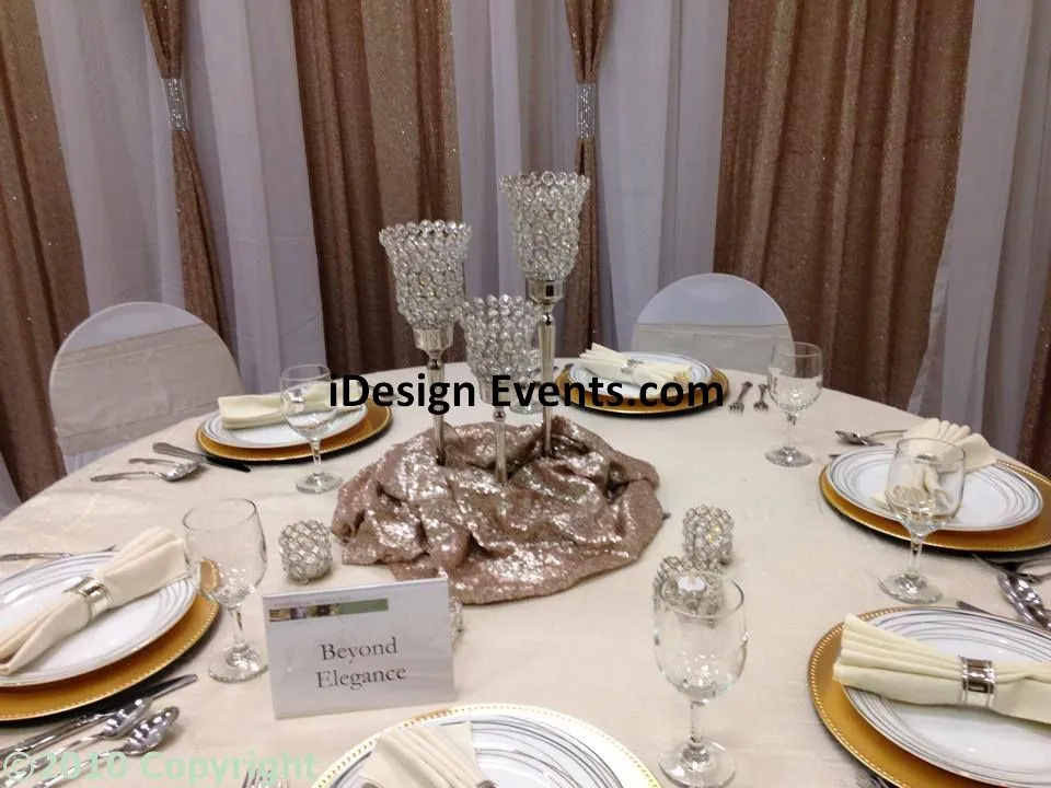 Elegant round table setting with gold and white decor for a formal event.