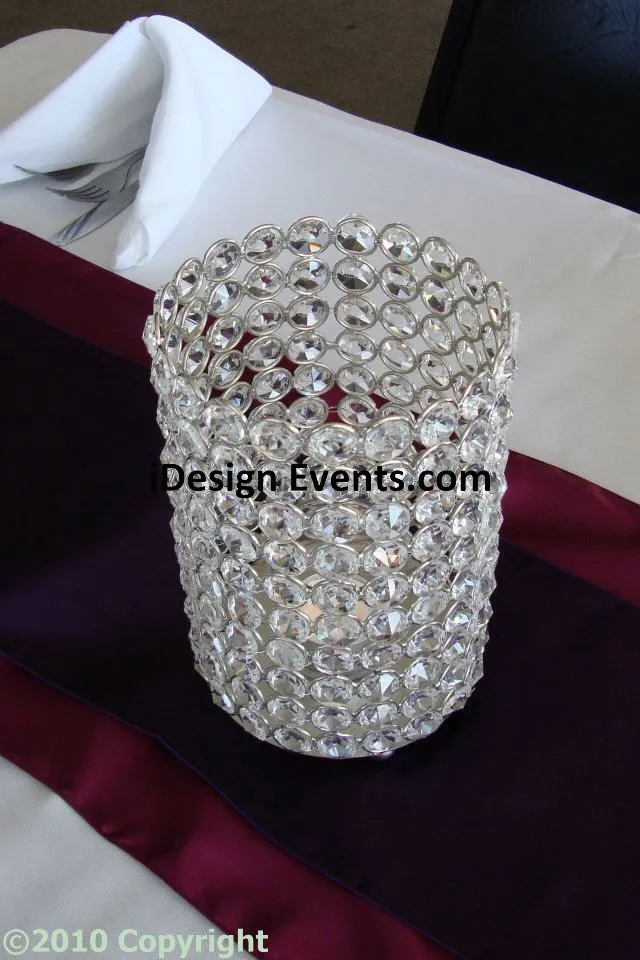 A cylindrical candle holder adorned with sparkling crystals.
