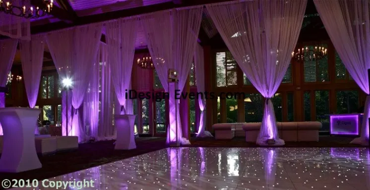 Futuristic roller coaster inside a vibrant, neon-lit indoor amusement park.