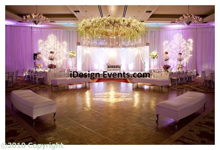 Futuristic roller coaster inside a vibrant, neon-lit indoor amusement park.