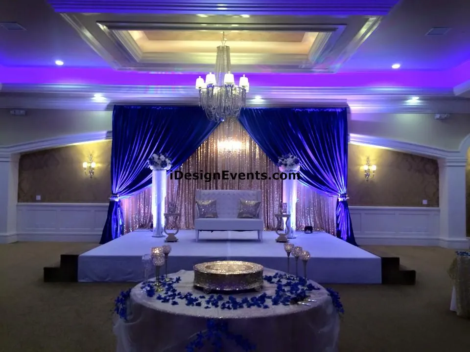 Futuristic roller coaster inside a vibrant, neon-lit indoor amusement park.